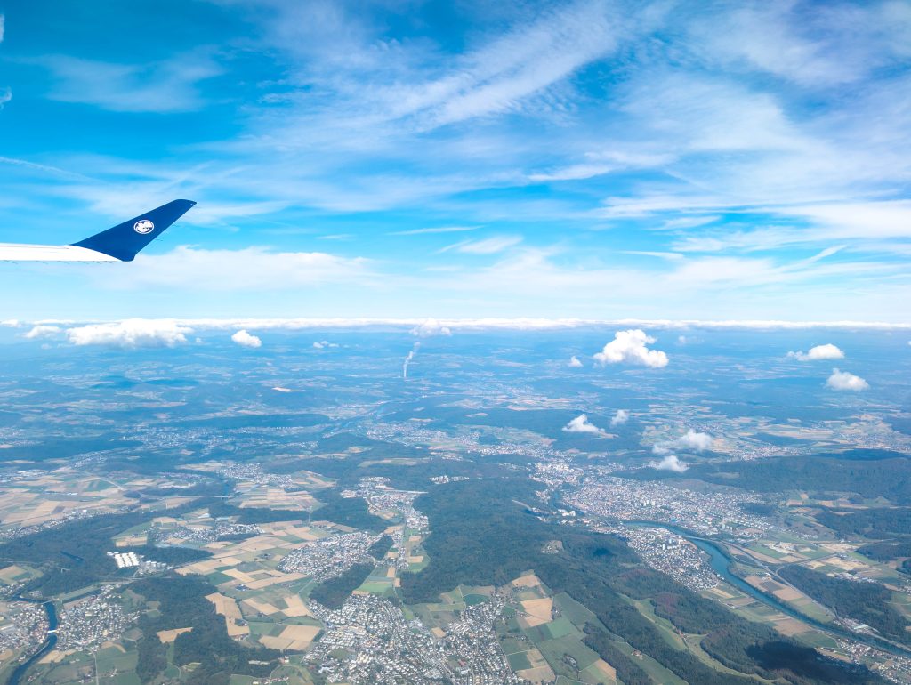 Air France aircraft wing flying high above European river valleys during the transit sector to Paris