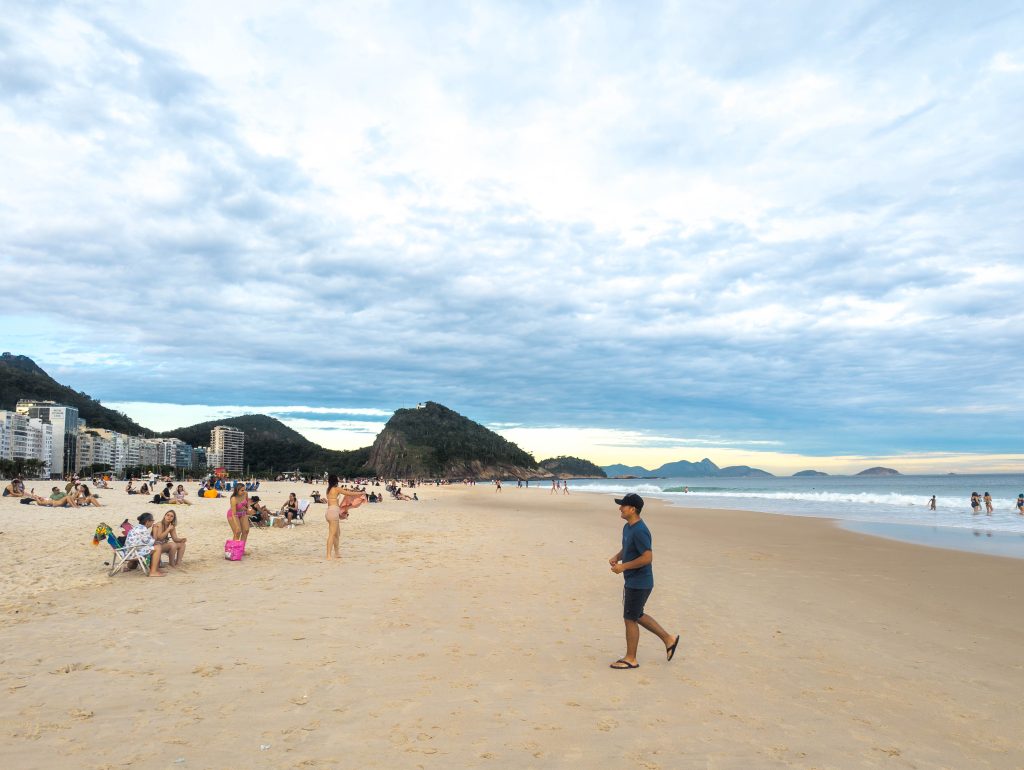 Ocean surf rolling onto the sand at Copacabana beach in Rio de Janeiro during late afternoon