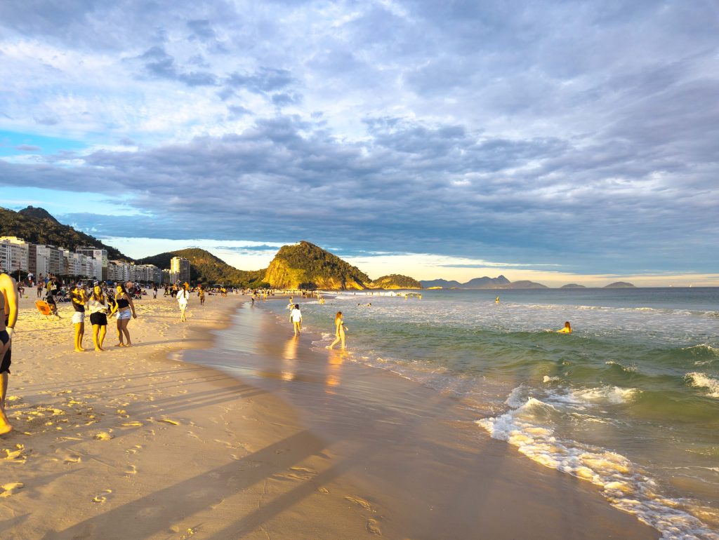 Evening atmosphere along Copacabana beach with breaking Atlantic waves and coastal hills