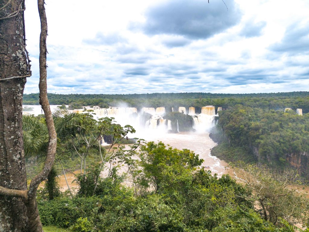 Rushing river current and white water rapids through the basalt gorge at Iguazu Falls