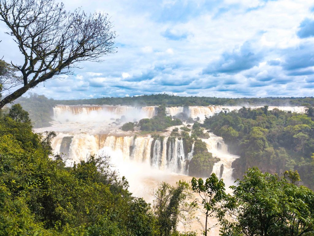 Massive waterfalls plunging over the precipice into the churning gorge at Iguazu Falls