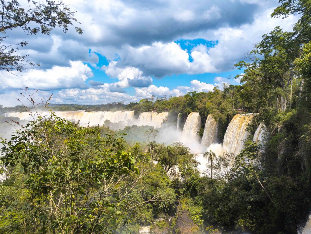 Massive volume of water rushing over the rocky ledge at the crest of the falls in Argentina