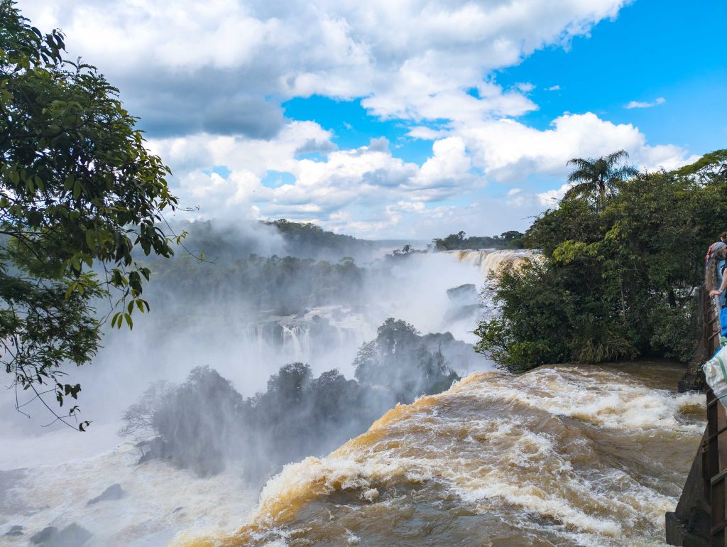 Wide panorama of cascading waterfalls and dense spray clouds in Argentine Iguazu National Park