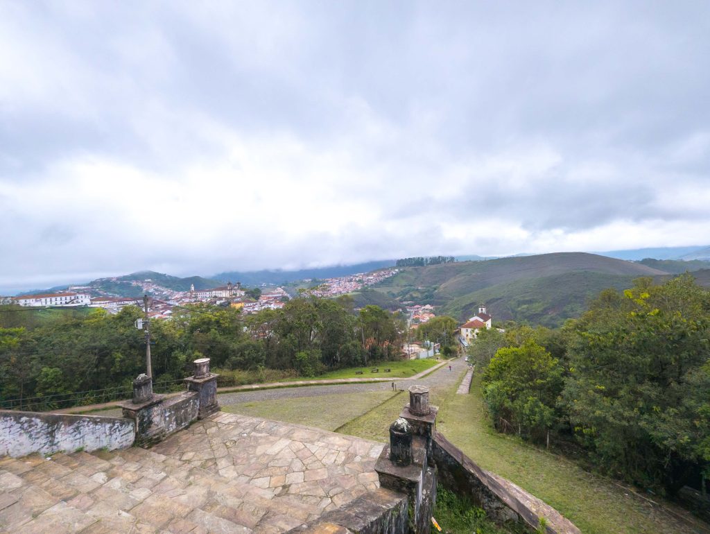 Stone steps overlooking the historic colonial rooftops and surrounding hills of Ouro Preto