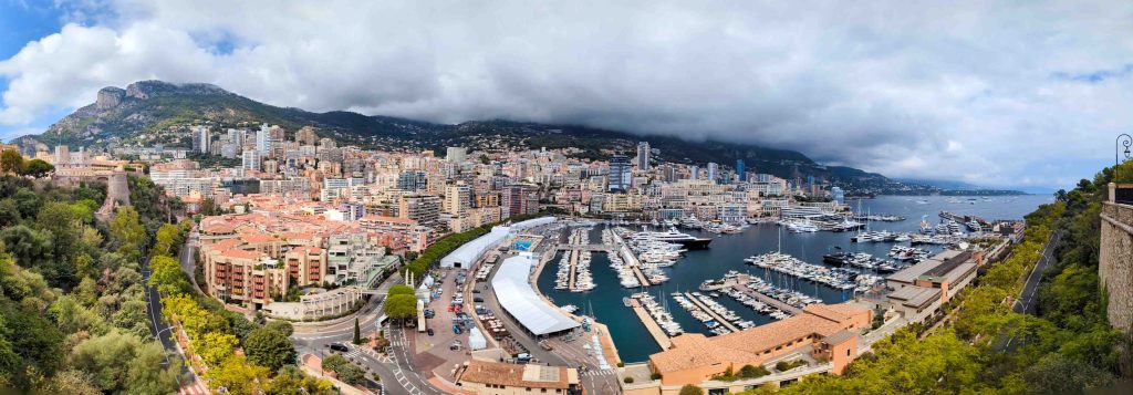Panoramic overlook of Monaco showing the Prince Palace on Le Rocher beside Port Hercule and Monte Carlo