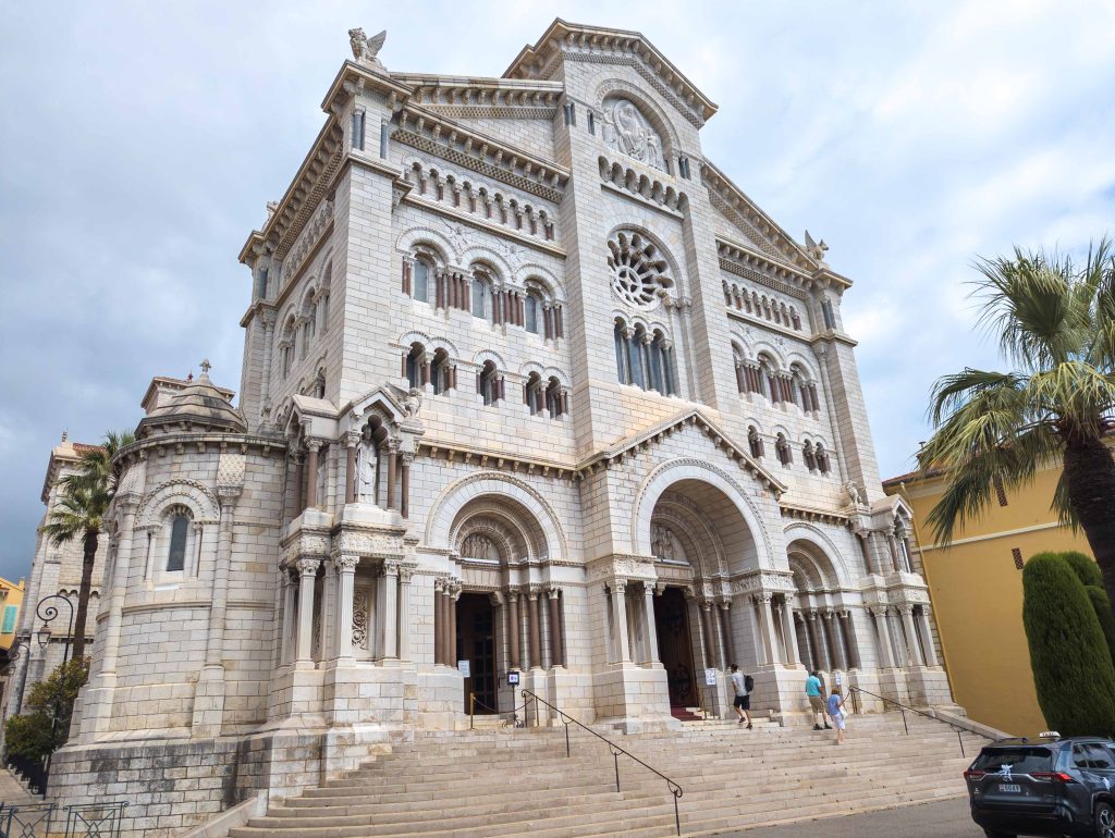 White Romanesque facade and marble entrance steps of the Cathedral of Our Lady Immaculate in Monaco