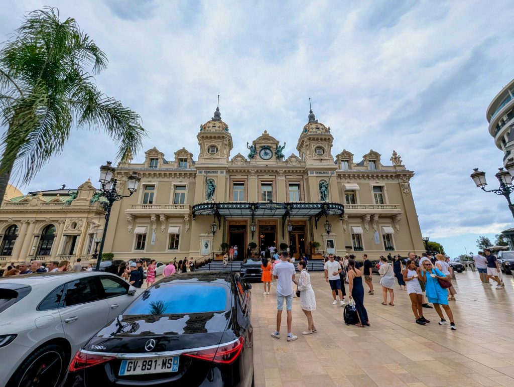 Place du Casino in Monte Carlo featuring the ornate Casino facade luxury sports cars and strolling visitors