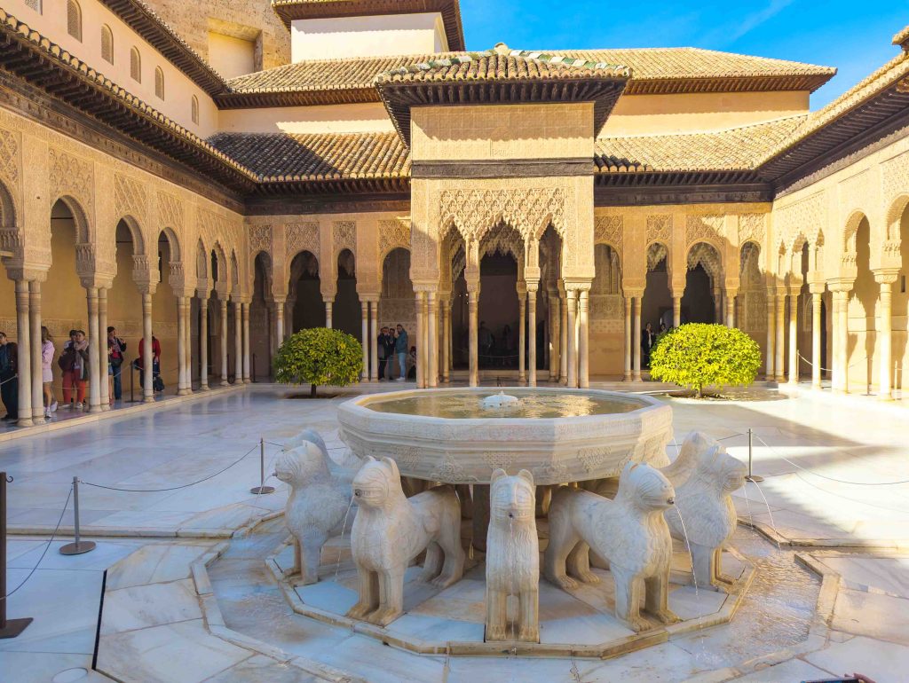 Twelve carved white marble lions supporting the central alabaster fountain basin in the Court of the Lions at the Alhambra in Granada